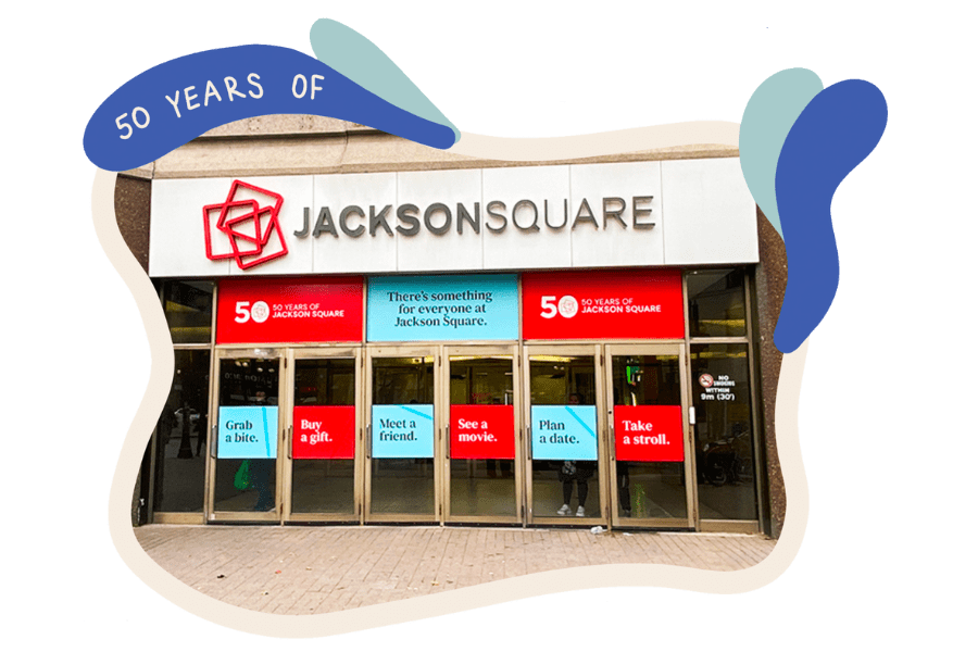 Main Entrance of Jackson Square at James and King in Downtown Hamilton, wit red and blue decals on the doors